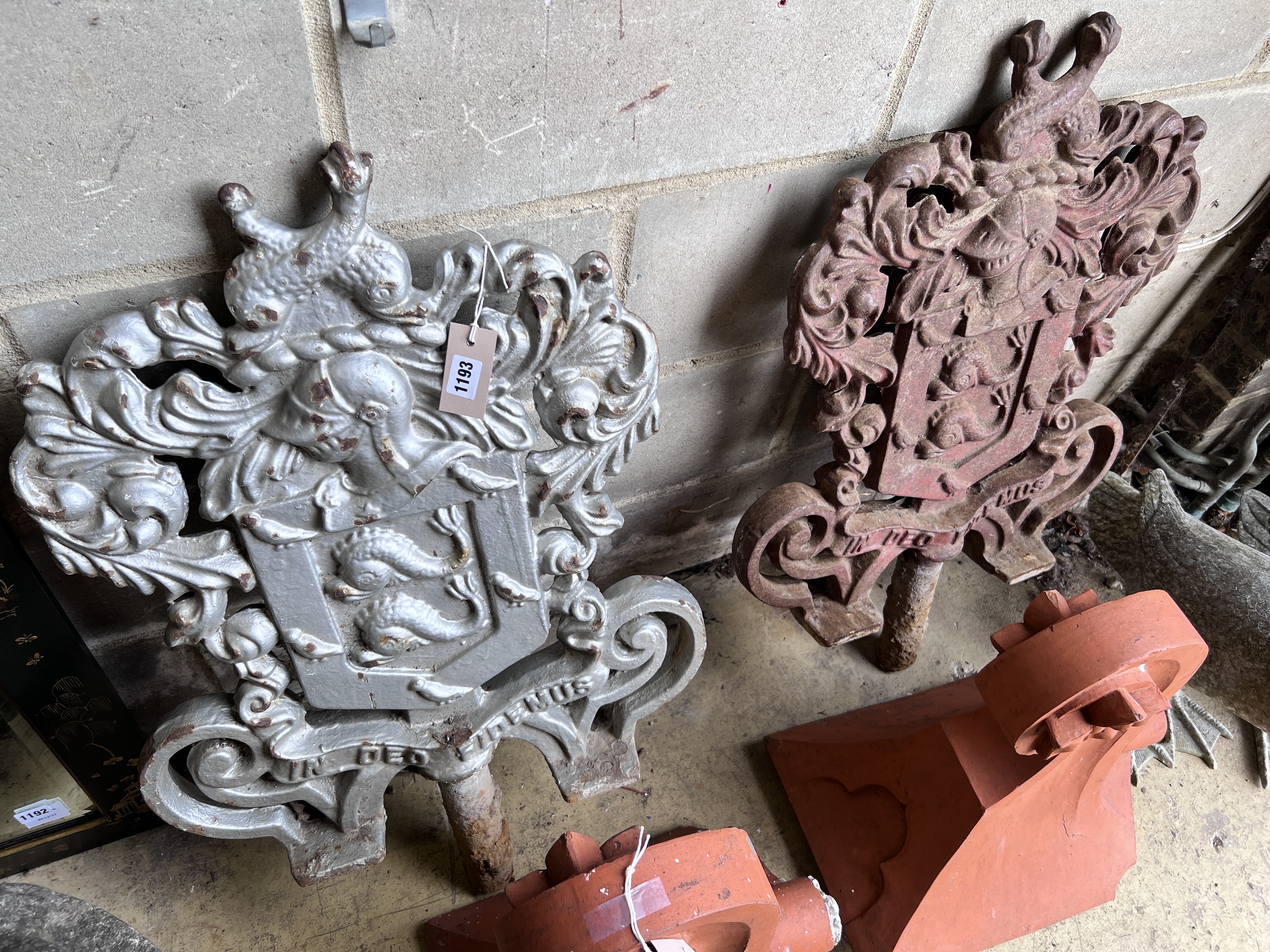 A pair of cast iron armorial capitals with motto 'In Deo Fidemus', height 82cm